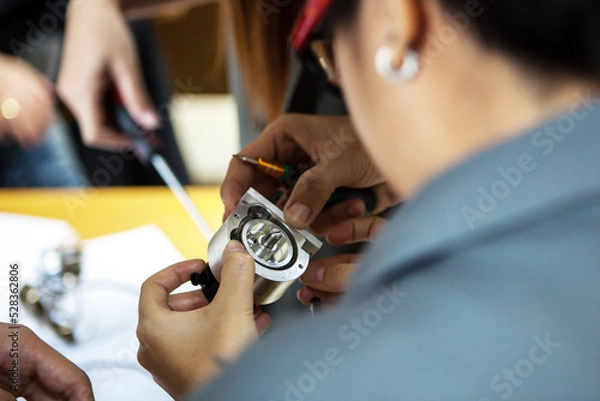 Fototapeta A young engineer and technician working with encoder