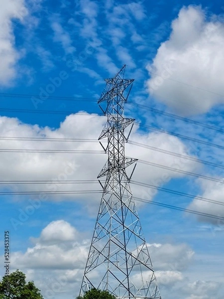 Obraz High voltage pole with blue sky ans white clouds.