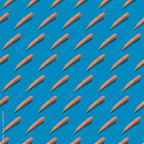 Fototapeta Pattern Fresh carrot pattern on blue background. 