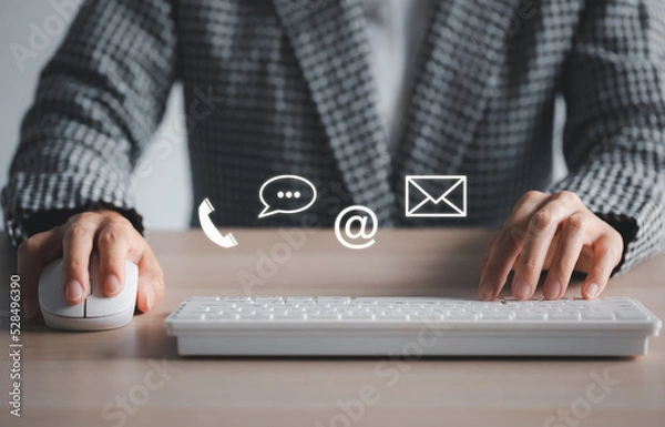 Obraz closeup woman using keyboard and mouse with phone, chat, address, mail icon above