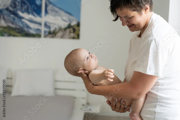Fototapeta picture of happy mother with baby in hands
