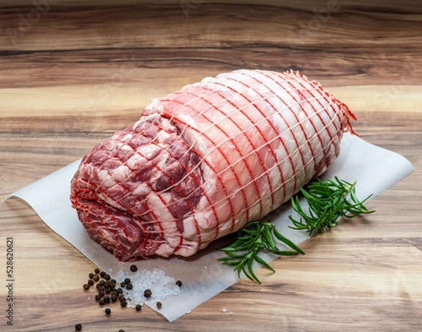 Obraz Boneless Leg of Lamb with rosemary, rock salt and peppercorn on wax paper