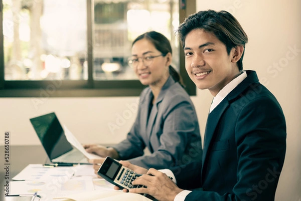 Fototapeta Two business leaders talk about charts, financial graphs showing results are analyzing and calculating planning strategies, business success building processes