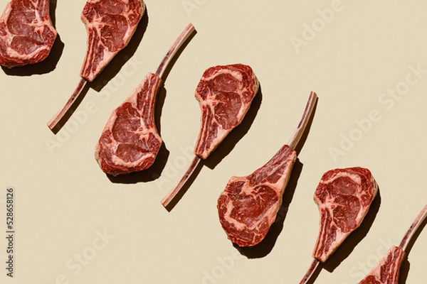Fototapeta Horizontal Pattern of Raw fresh meat Tomahawk Steak on beige background flatlay food