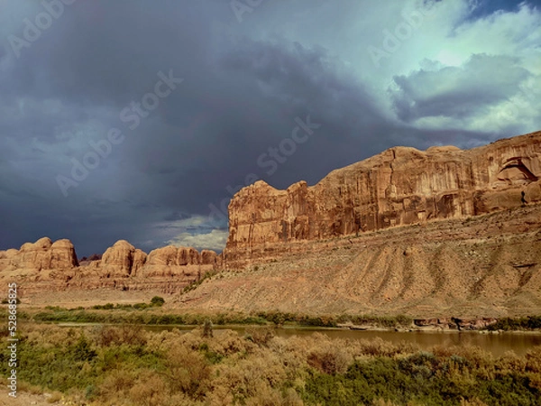 Obraz Storm clouds behind red rock cliffs
