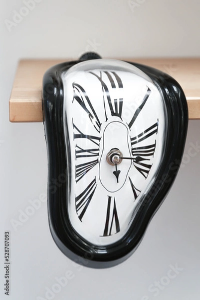 Obraz Decorative clocks drain off the shelf. The clock is a symbol of the impermanence of time.