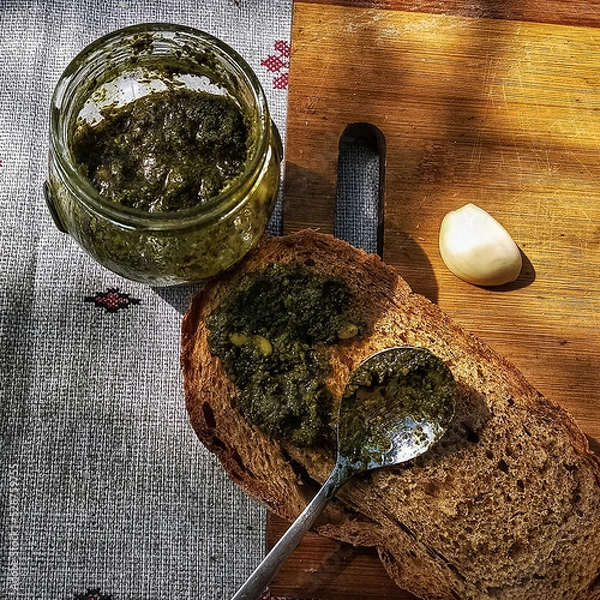 Fototapeta Village breakfast. Pesto. Italian food. Baselic, parmesan, olive oil, black bread. Simple food. Very tasty