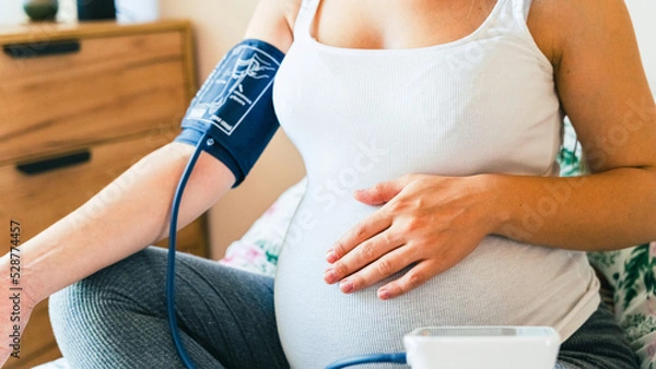 Fototapeta Pregnant blood test hypertension pressure. Pregnancy mother with blood test sphygmomanometer check pressure. Pregnancy, medicine health care concept.