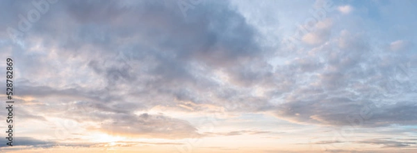 Fototapeta Awe light colored cloudy sky at sunset for texture and background