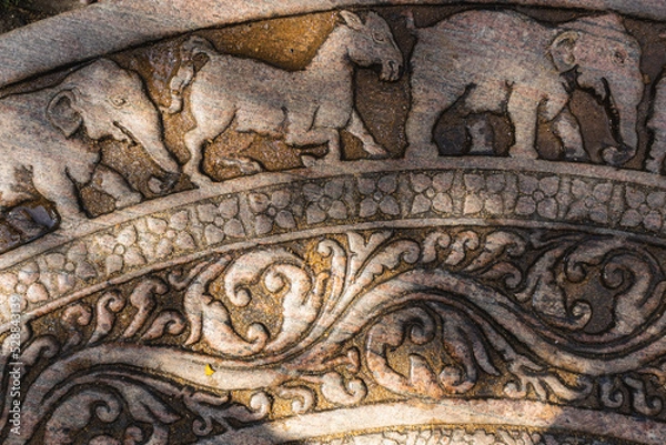 Fototapeta Moonstone also known as Sandakada Pahana, is a unique feature of the architecture of ancient Sri Lanka. It is an elaborately carved semi-circular stone slab, usually placed at the bottom of entrances.