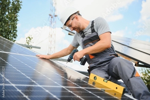Fototapeta A man working at solar power station.