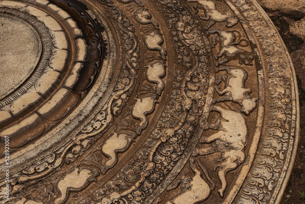 Fototapeta Moonstone or Sandakada Pahana, is a unique feature of the architecture of ancient Sri Lanka.It is an elaborately carved semi-circular stone slab, usually placed at the bottom of staircase. 