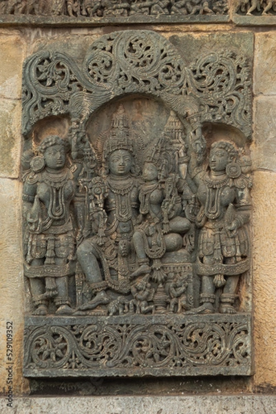 Fototapeta The Depicting of Lord Shiva and Parvati on the Chennakeshawa Temple, Belur,  It was commissioned by King Vishnuvardhana in 1117 CE, Hassan, Karnataka, India.
