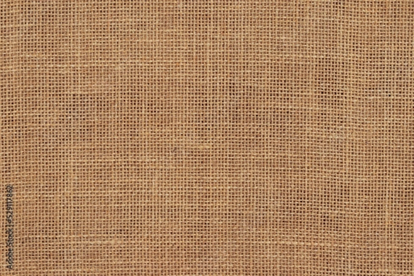 Fototapeta Brown burlap cloth background or sack cloth for packing. Natural linen threads texture. Sackcloth, empty space. Wrapping detail, old grainy cotton backdrop close-up.