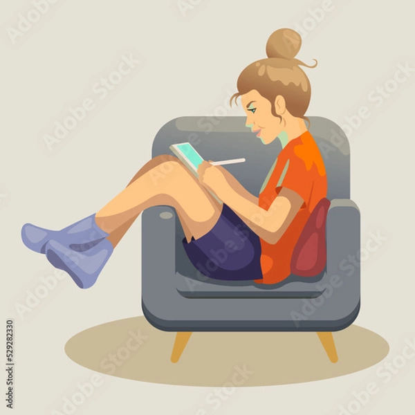 Obraz A girl draws on a tablet in a chair