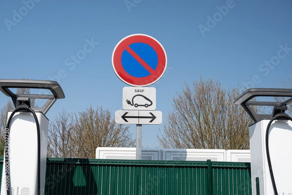 Obraz Close-up of a no-parking sign and a pictogram of an electric car at an electric charging station.