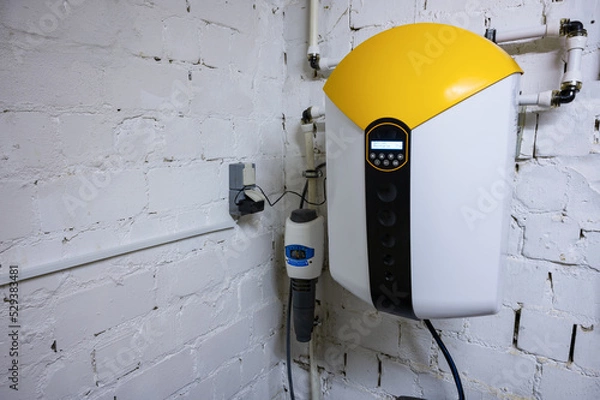 Fototapeta Water softening and descaler system for water treatment mounted to a wall reduces hard water and scaling