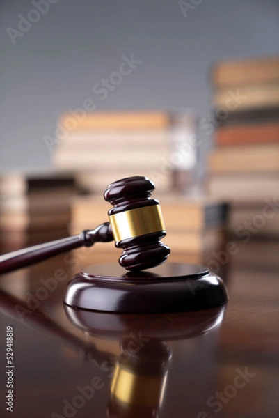 Fototapeta Law theme - judge office. Gavel and legal books on the judge desk. 