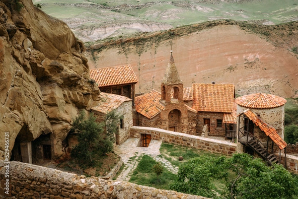 Fototapeta View of David Gareja Lavra orthodox monastery caves built in rock Georgia in semi-desert. 