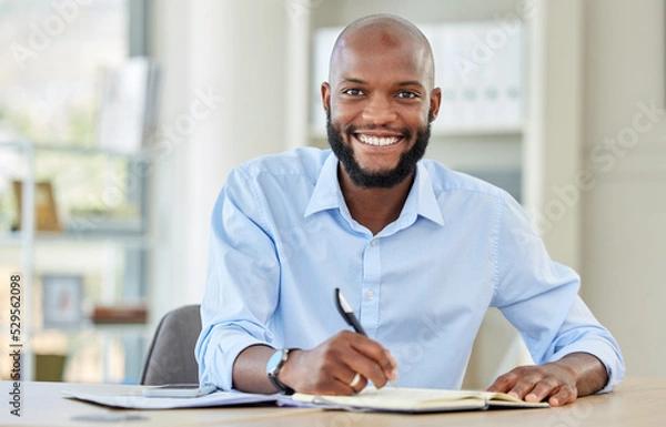 Fototapeta Notebook planning, writing and businessman working on financial strategy in work office, happy with corporate ccompany and reminder in book. Portrait of happy African accountant at accounting startup