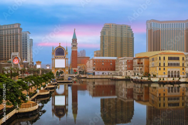 Fototapeta Macau cityscape. Landscape of Macau business building with reflection with blue sky. Macaw city at dusk.