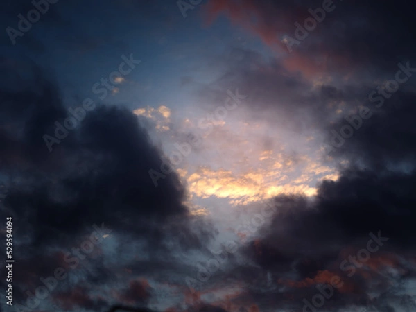 Obraz Clouds in the sunset sky.