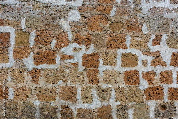Fototapeta The texture of the stone wall. Part of a stone wall, for background or texture