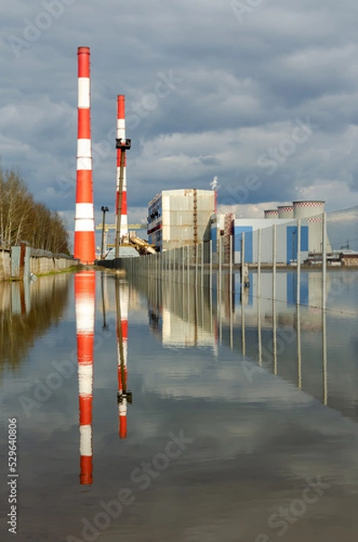 Obraz power plant reflection water sky clouds pipes fence cooling tower