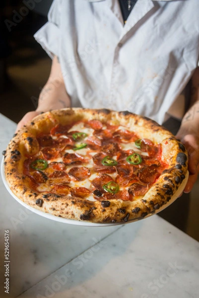 Obraz Pizzaiolo holding  pizza