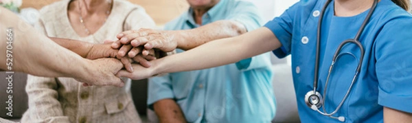 Fototapeta Panoramic banner background of elderly human bare hands join together in the middle under with indoors light. Concept Elderly nursing care help and support. Service mind for senior people.