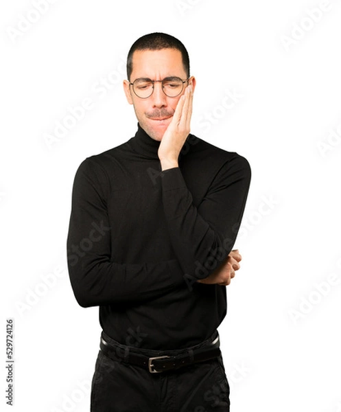 Obraz Concerned young man with a toothache gesture