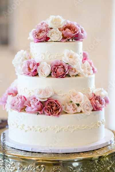 Fototapeta Multi tiered wedding cakes with blooms