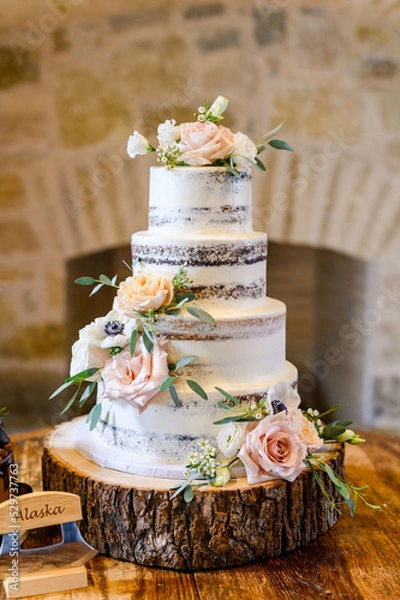 Fototapeta Multi tiered wedding cakes with blooms