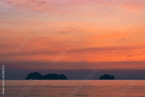 Obraz Colorful dramatic sky over the sea and islands. Reflections in the water.