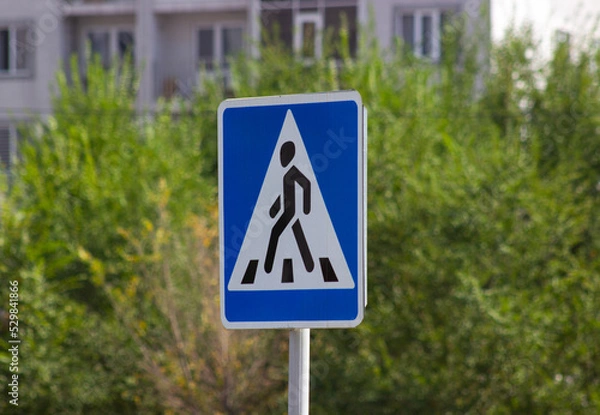 Obraz Pedestrian triangle road sign blue background