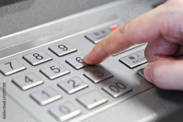 Obraz Human hand enter atm banking cash machine pin code
