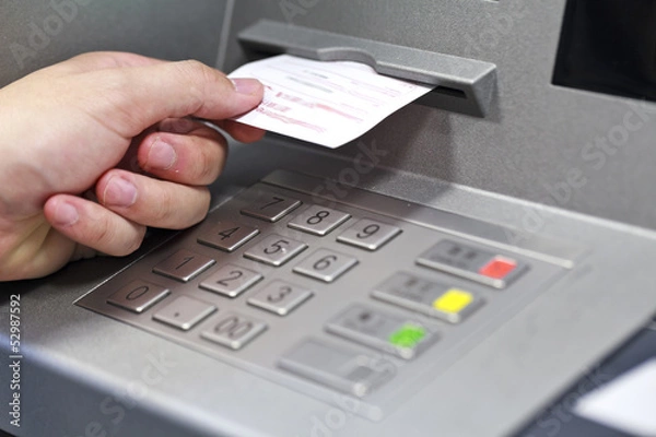 Fototapeta A hand taking a receipt of an Automated Teller Machine