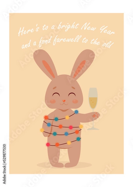Fototapeta A cute little rabbit wrapped in a garland with lanterns smiles and holds a glass of champagne in its paw. Wish inscription. New Year card, 2023 - Year of the Rabbit, Christmas. greeting card