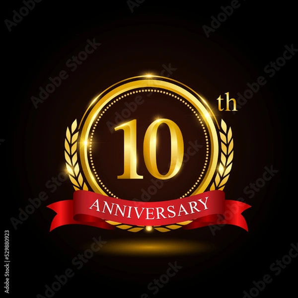 Fototapeta 10th golden anniversary template design, with shiny ring and red ribbon, laurel wreath isolated on black background, logo vector01