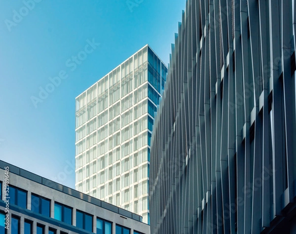Fototapeta Looking up at modern office buildings in the city center