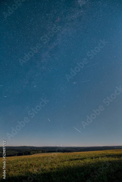 Obraz The Perseid meteor shower on August 12, 2022, photographed from the summit of the Witthoh near Tuttlingen in Germany.