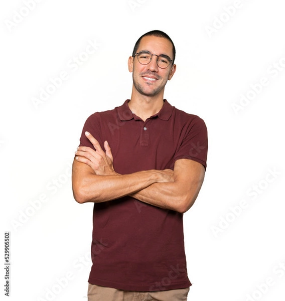 Obraz Satisfied young man with crossed arms gesture