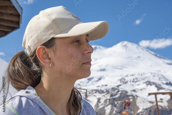 Fototapeta Woman on the observation deck against the backdrop of the Caucasian snow-capped mountains