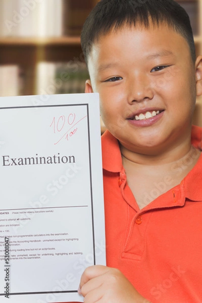 Fototapeta Young asian boy with full score examination sheets