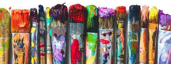 Fototapeta Row of artist paintbrushes closeup. Artistic brushes smeared with paints, isolated.