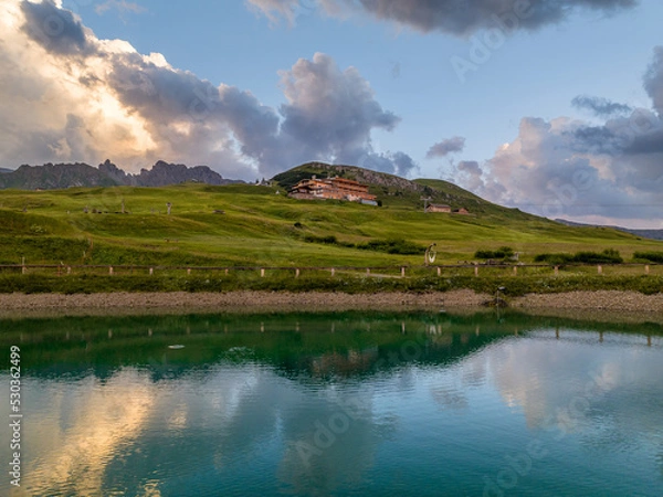 Fototapeta Sunrise in the Dolomites mountains with fog and mist rolling around the peaks. Hiking path leading to the hills. 