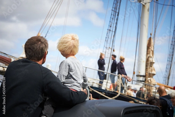 Fototapeta a family watching the tall ship race in Aalborg
