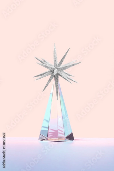 Fototapeta Minimal futuristic Happy New 2023 year concept. Shiny crystal glass prism with a silver star ornament on orange background. Surreal Christmas tree idea. Pastel holiday aesthetic.