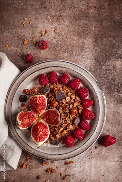 Obraz Chocolate granola with almond milk, raspberries, figs and honey.