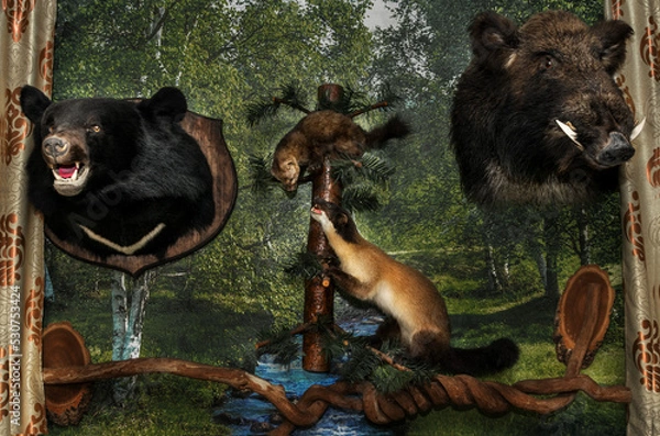 Fototapeta Stuffed animals of various animals are located on the wall and on a branch.